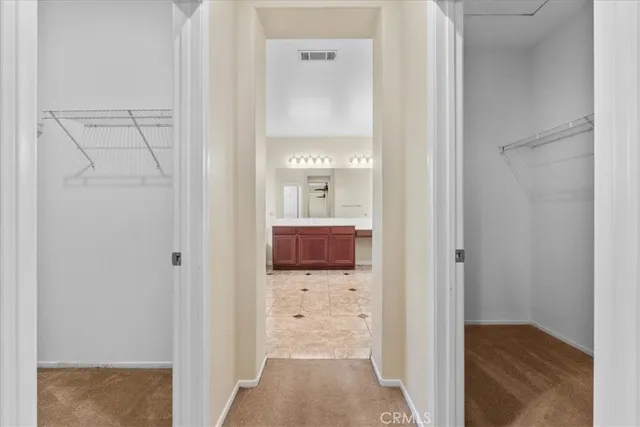a view of a hallway with wooden floor and closet