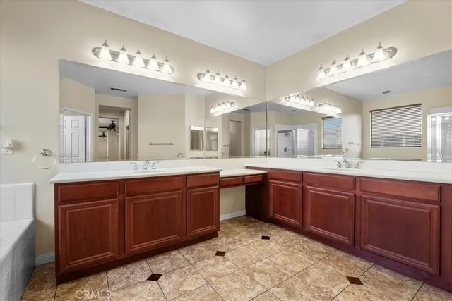 a spacious bathroom with a sink and a large mirror