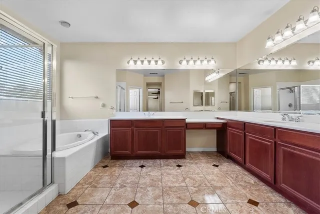 a large bathroom with a sink a large mirror and a bathtub