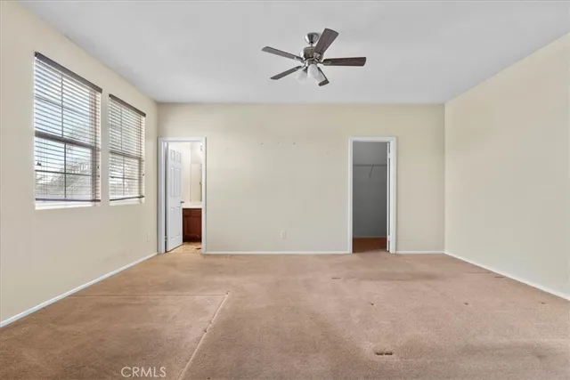 a view of a livingroom with a ceiling fan and window