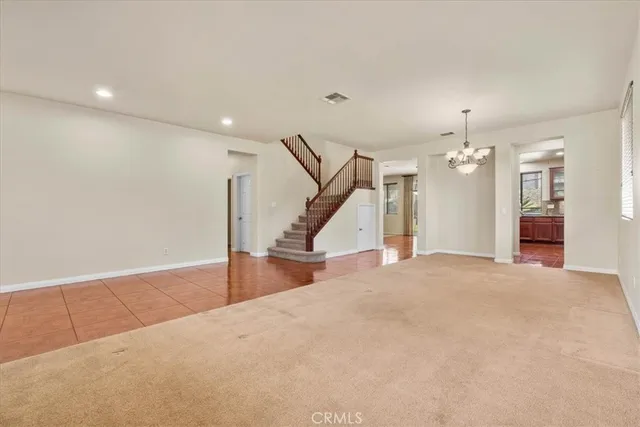 a view of a livingroom with wooden floor and stairs