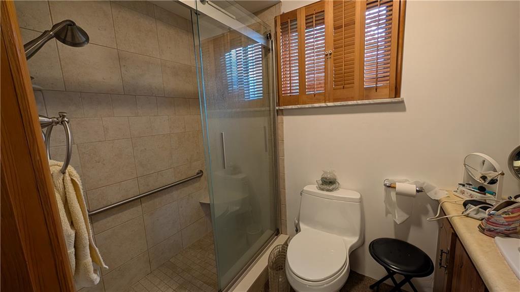 180 Liberty Street Perryopolis, PA 15473 - Photo 17 of 21 a white toilet sitting next to a bathroom sink and a shower