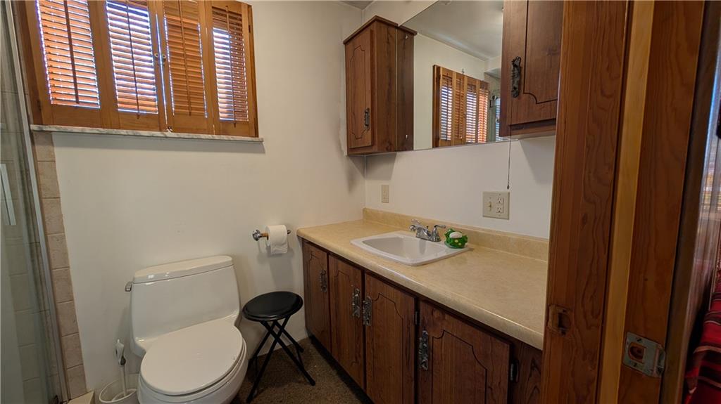 180 Liberty Street Perryopolis, PA 15473 - Photo 19 of 21 a bathroom with a granite countertop toilet sink and mirror