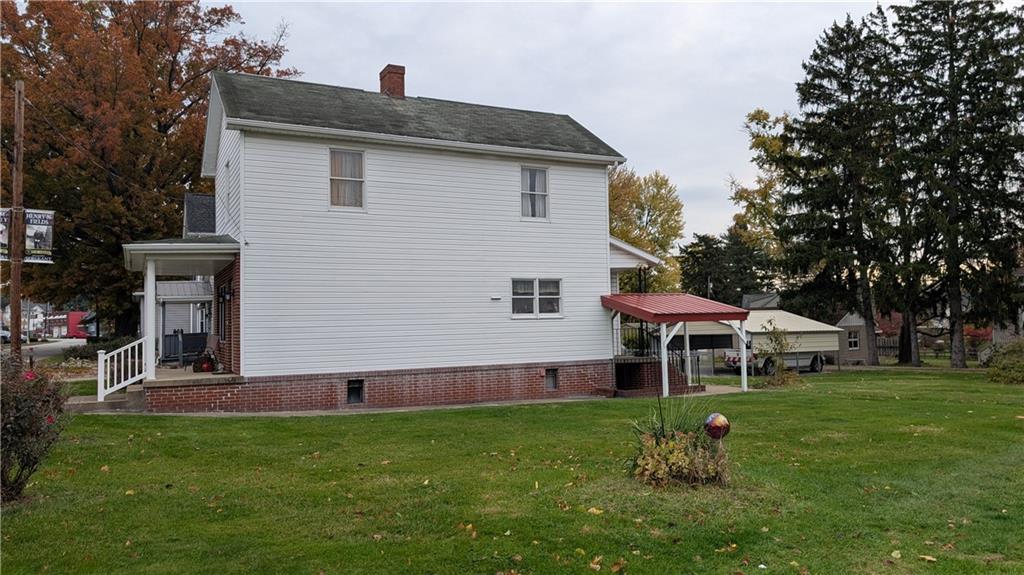 180 Liberty Street Perryopolis, PA 15473 - Photo 4 of 21 a front view of a house with a yard table and chairs