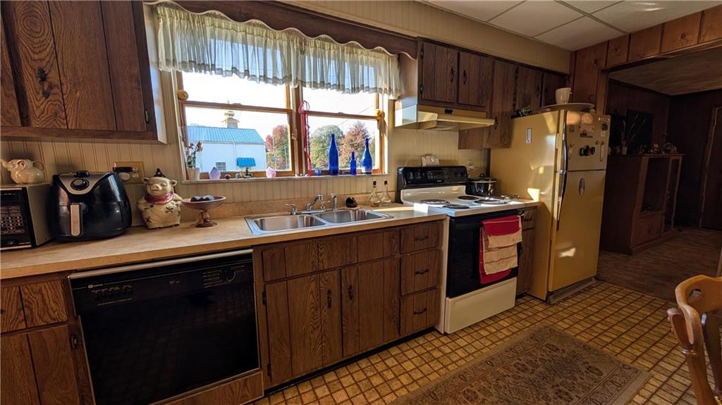 180 Liberty Street Perryopolis, PA 15473 - Photo 8 of 21 a kitchen with stainless steel appliances granite countertop a refrigerator a sink a stove a counter space and cabinets