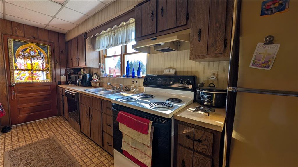 180 Liberty Street Perryopolis, PA 15473 - Photo 9 of 21 a kitchen with stainless steel appliances granite countertop a stove a sink dishwasher and cabinets