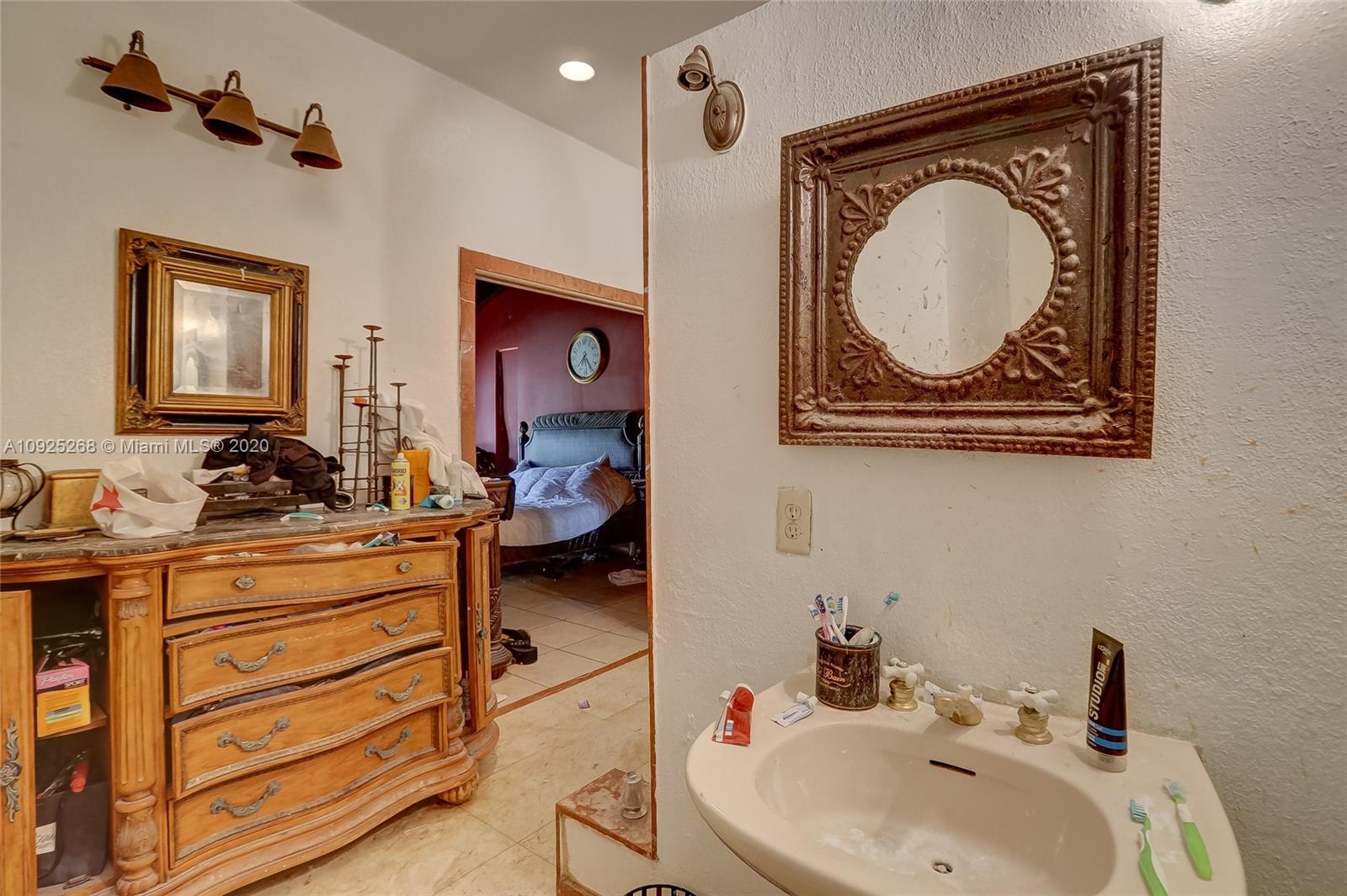 3501 North Park Road Hollywood, FL 33021 - Photo 16 of 30 a bathroom with a sink a mirror and a toilet