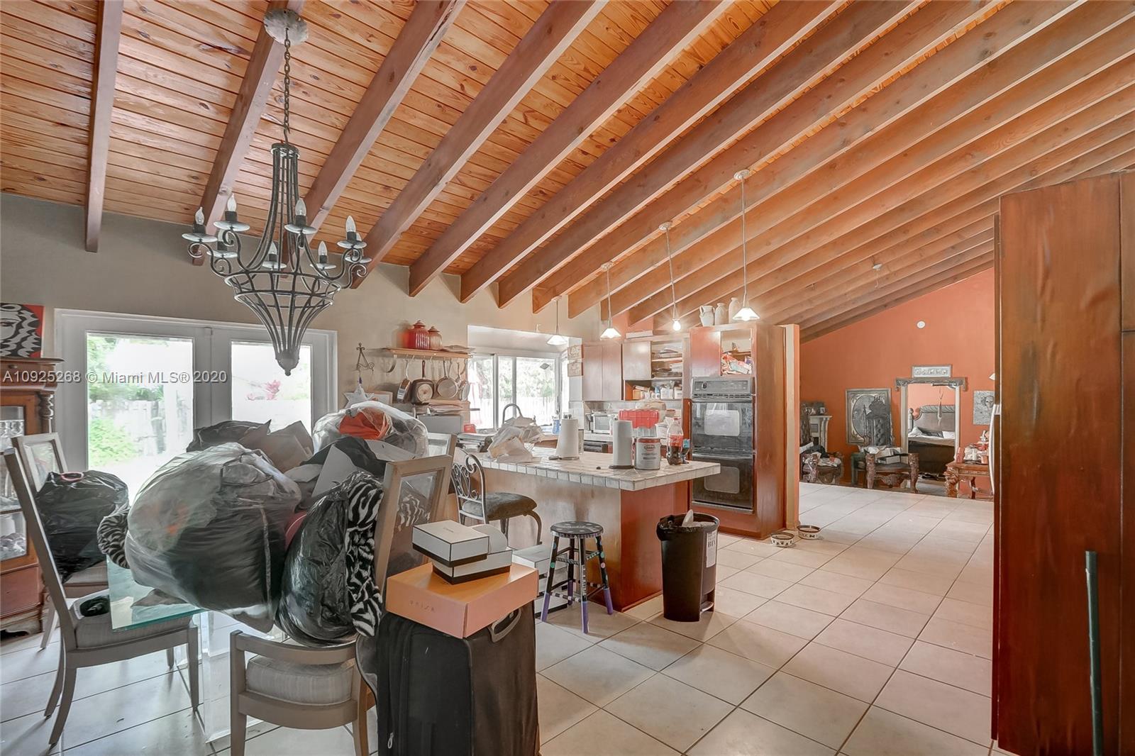 3501 North Park Road Hollywood, FL 33021 - Photo 21 of 30 a view of a dining room with furniture chandelier and kitchen view