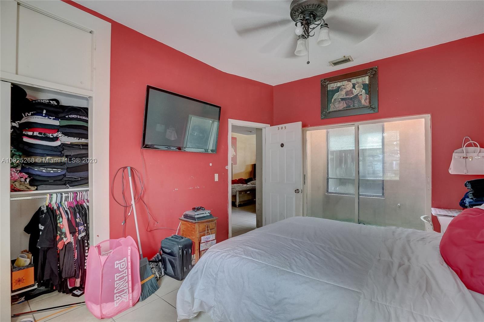 3501 North Park Road Hollywood, FL 33021 - Photo 27 of 30 a bedroom with a bed and a flat screen tv