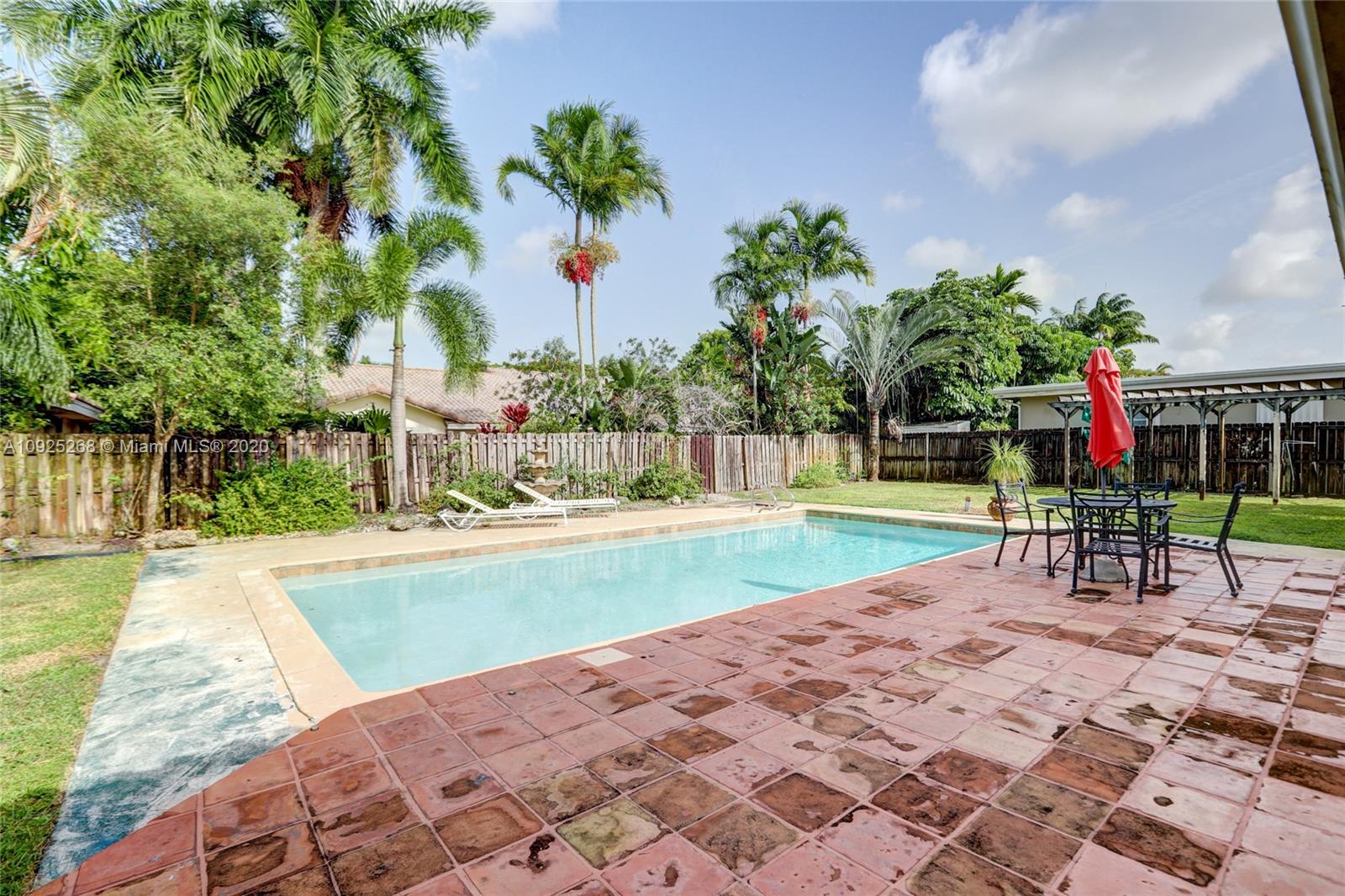 3501 North Park Road Hollywood, FL 33021 - Photo 30 of 30 a view of a swimming pool with a bench and plants