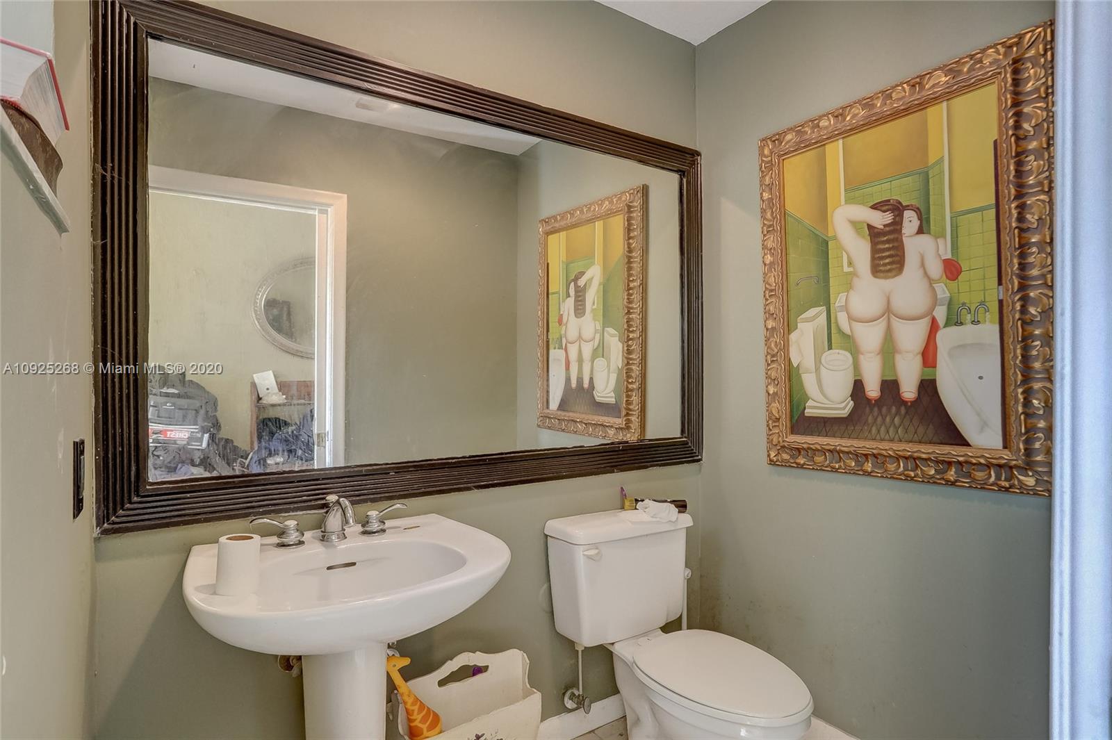 3501 North Park Road Hollywood, FL 33021 - Photo 7 of 30 a bathroom with a toilet sink and mirror