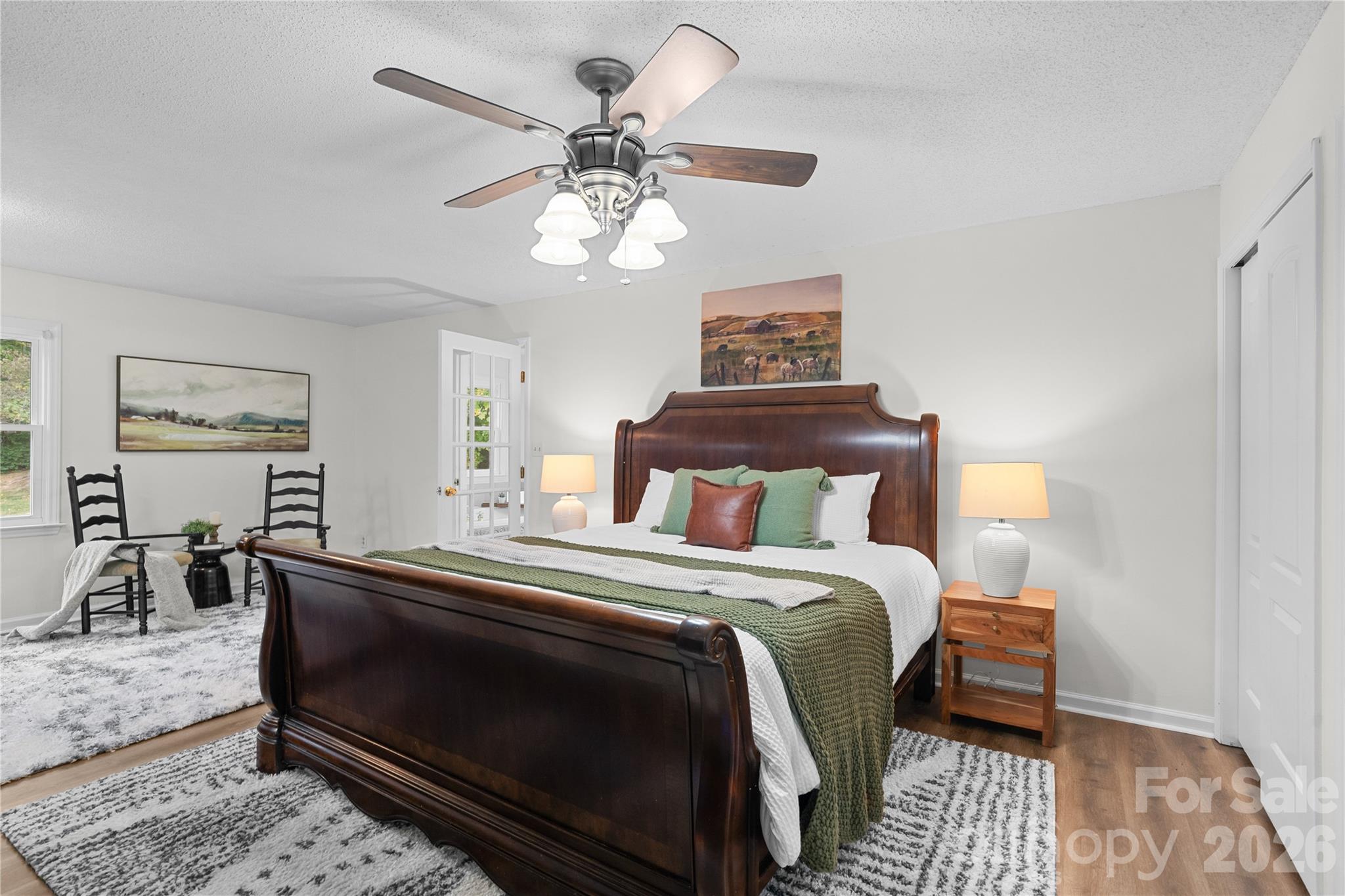 1335 Blacksnake Road Stanley, NC 28164 - Photo 14 of 31 a bedroom with a bed and a chandelier