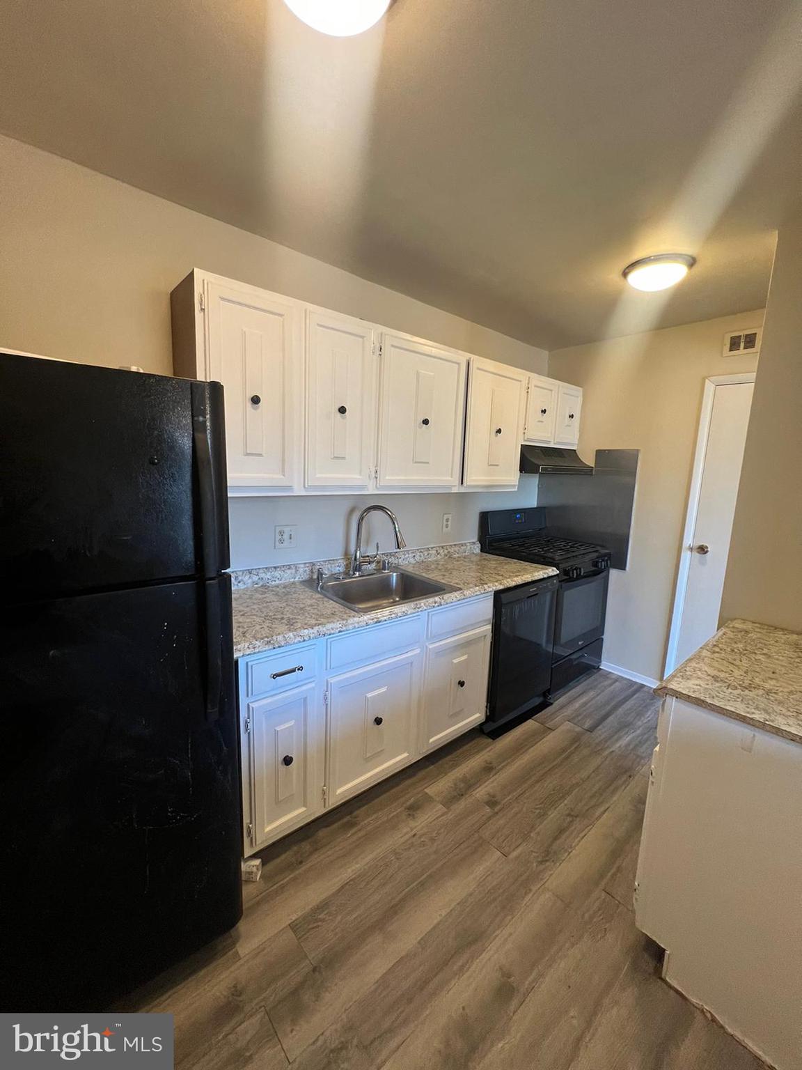 3732 Bel Pre Road, Unit 9 Silver Spring, MD 20906 - Photo 16 of 21 a kitchen with granite countertop a refrigerator a sink and dishwasher