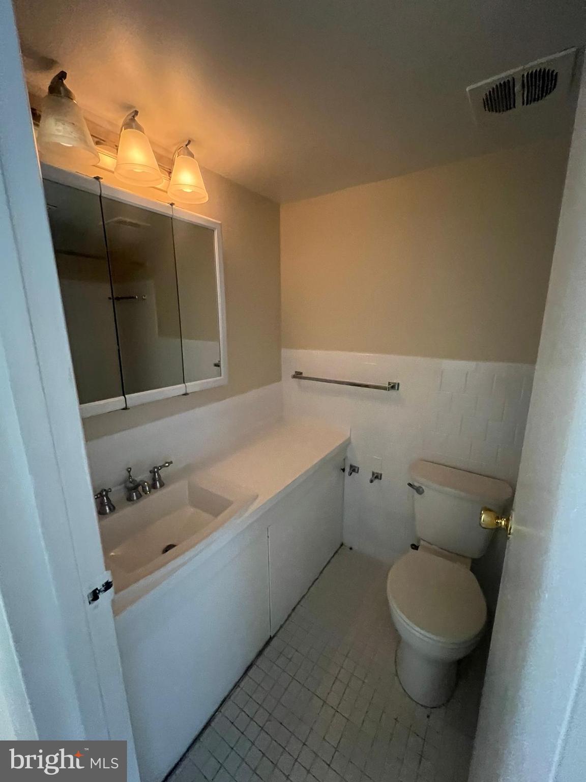 3732 Bel Pre Road, Unit 9 Silver Spring, MD 20906 - Photo 18 of 21 a bathroom with a toilet sink and mirror