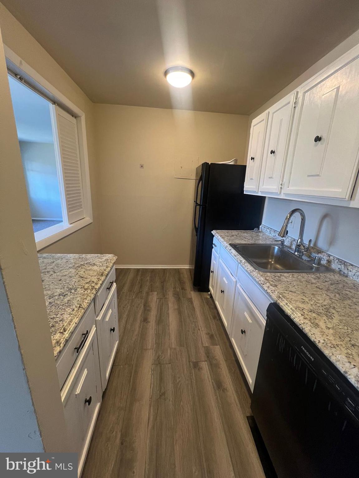 3732 Bel Pre Road, Unit 9 Silver Spring, MD 20906 - Photo 7 of 21 a kitchen with granite countertop a sink stove and cabinets