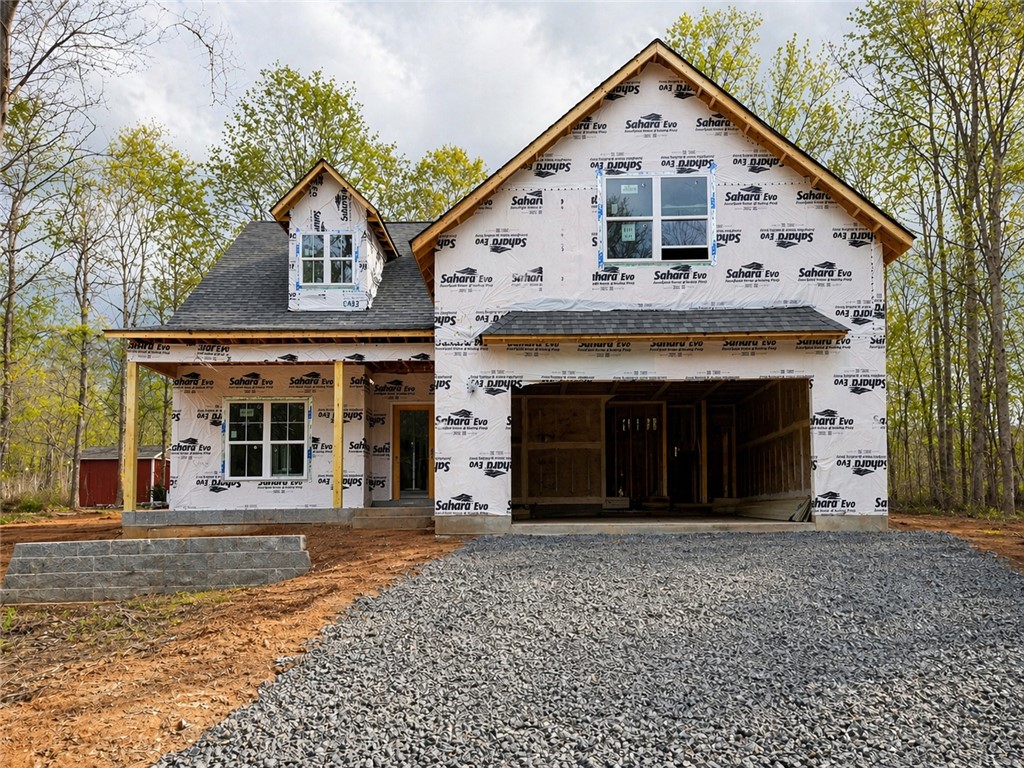 This new construction home features a classic design with an inviting porch and attached garage.