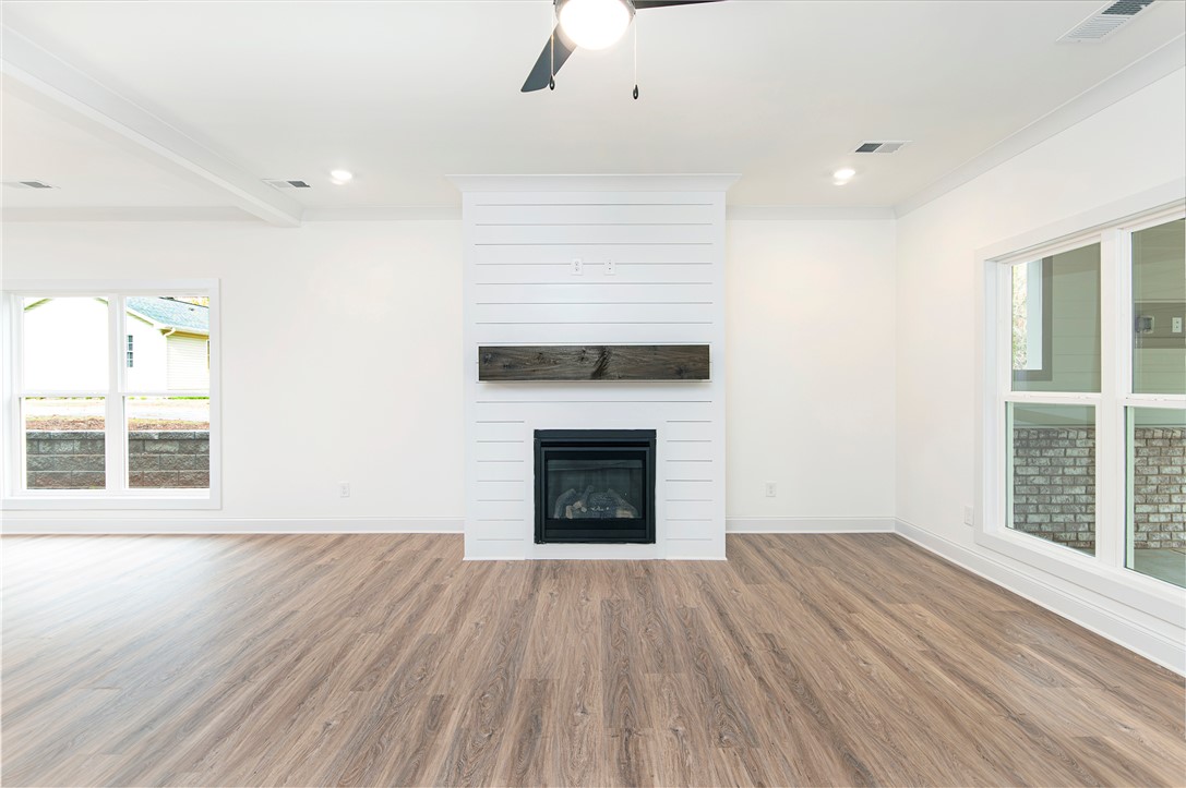 328 Point Road Westminster, SC 29693 - Photo 11 of 37 This bright living space features a cozy fireplace, setting a warm and inviting atmosphere.