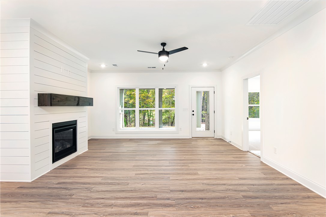 328 Point Road Westminster, SC 29693 - Photo 13 of 37 This bright living space features elegant flooring and a cozy fireplace, perfect for relaxation.