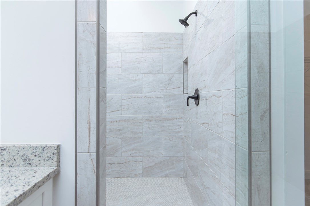 328 Point Road Westminster, SC 29693 - Photo 20 of 37 This modern bathroom features a spacious shower with sleek finishes and ample natural light.