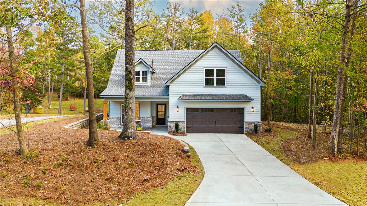 328 Point Road Westminster, SC 29693 - Photo 2 of 37 This charming modern farmhouse offers a serene retreat surrounded by lush natural landscaping.