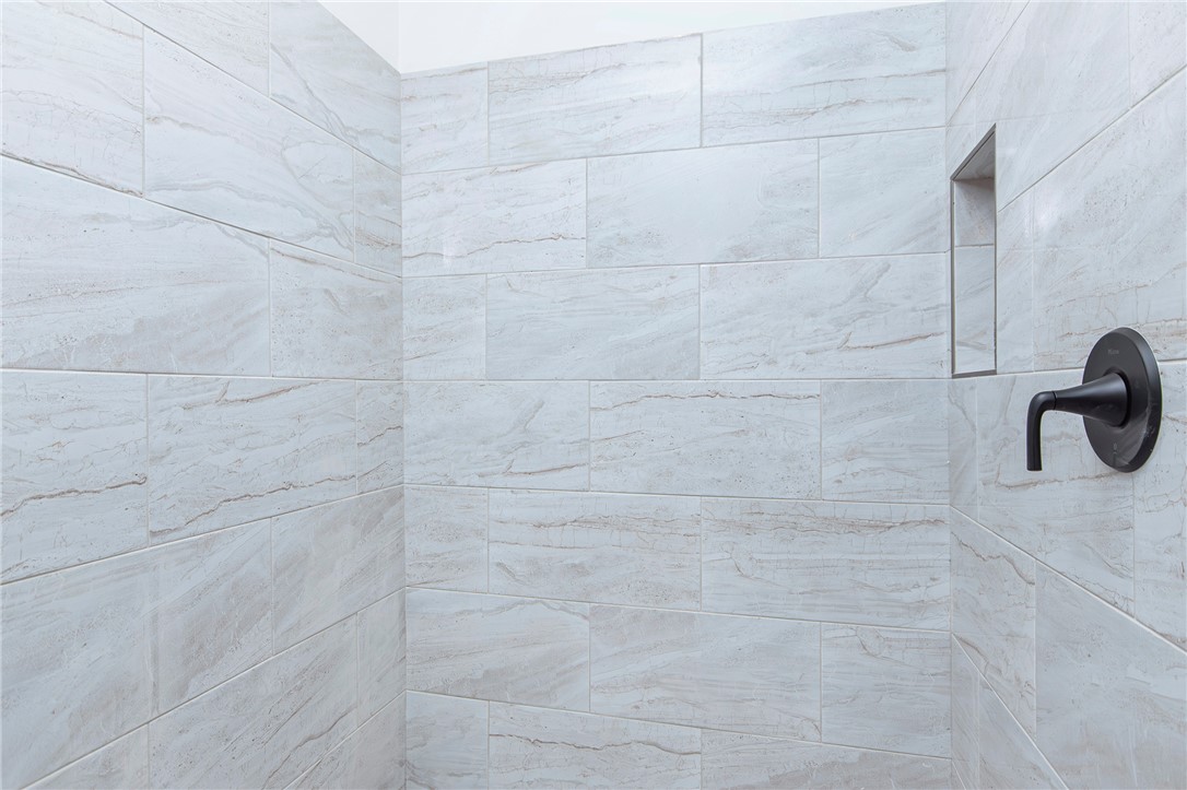 328 Point Road Westminster, SC 29693 - Photo 21 of 37 This shower features large format tiles and a convenient built-in niche for toiletries.