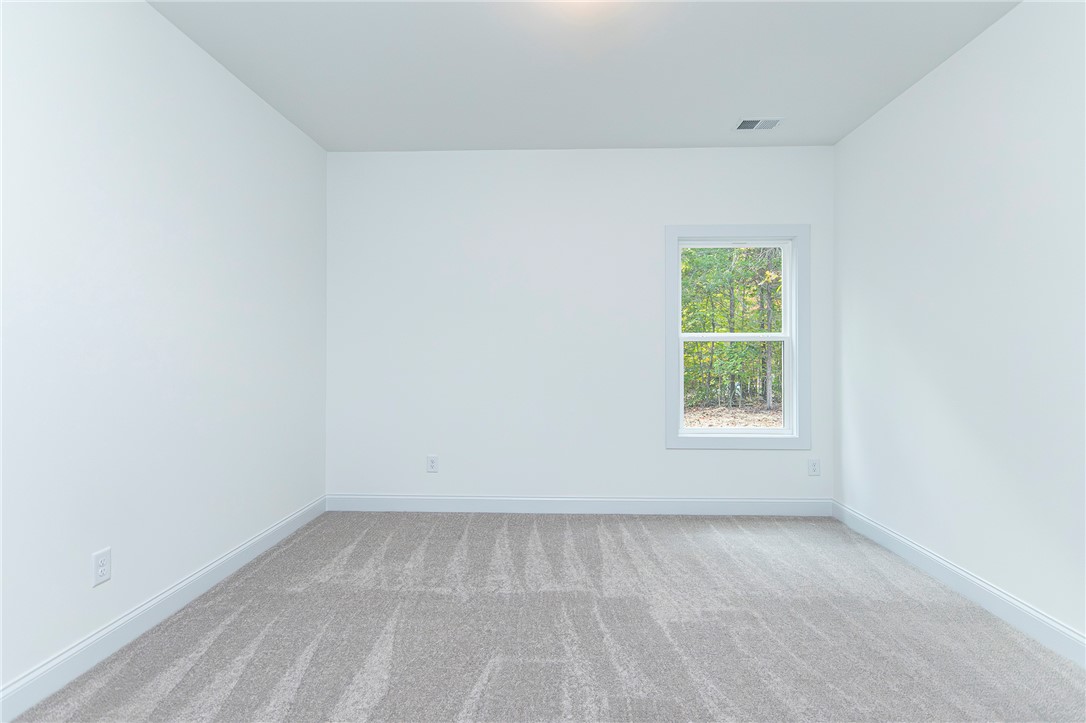 328 Point Road Westminster, SC 29693 - Photo 24 of 37 This spacious room features ample natural light, soft carpeting, and a tranquil view of surrounding greenery.