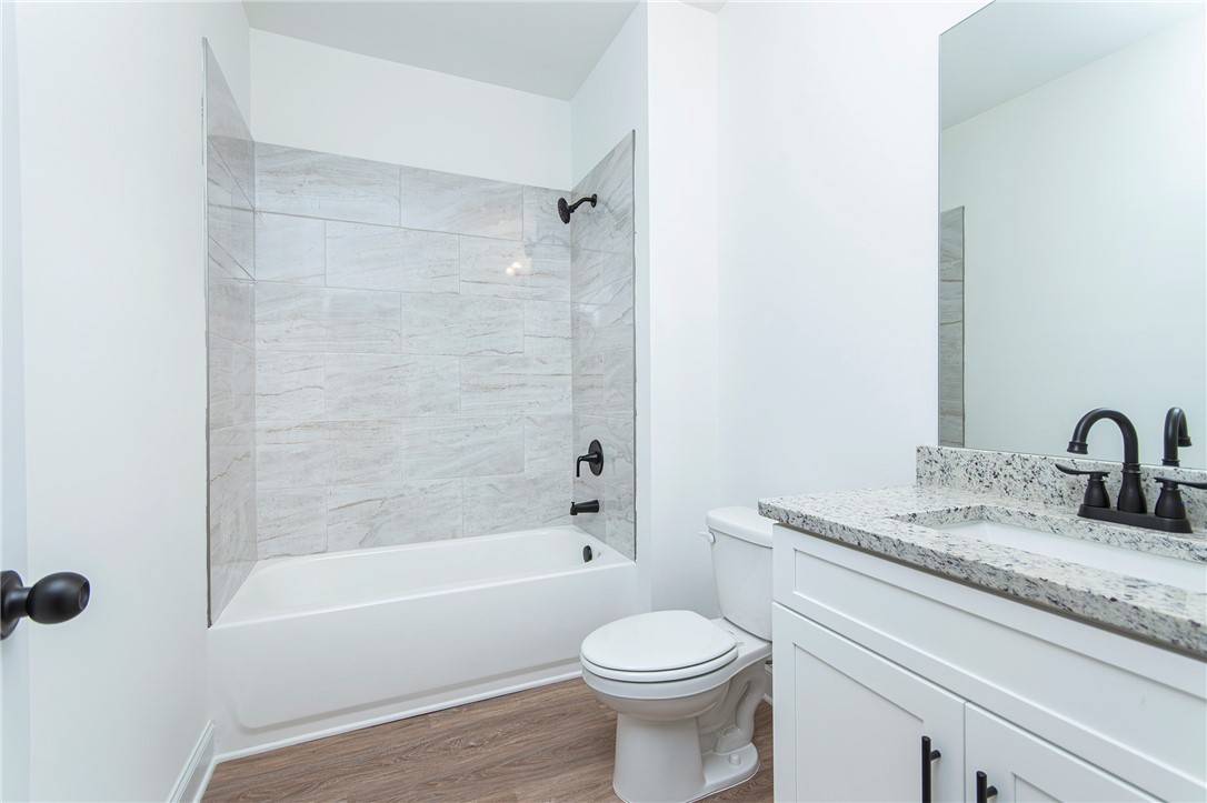 328 Point Road Westminster, SC 29693 - Photo 26 of 37 This bathroom features a contemporary design with a sleek vanity and a tiled shower.