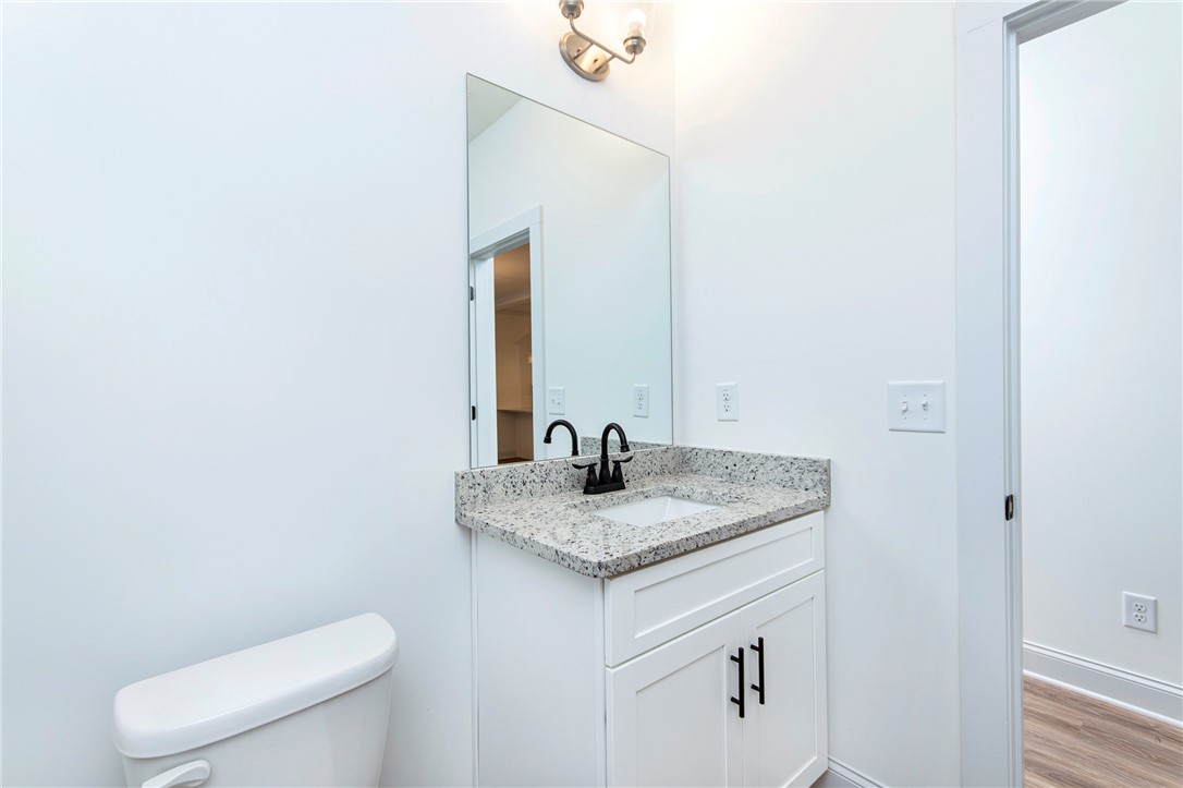 328 Point Road Westminster, SC 29693 - Photo 27 of 37 This bathroom features a contemporary vanity with a granite countertop and a sleek, modern faucet.