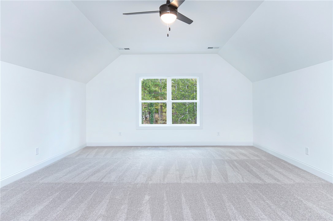 328 Point Road Westminster, SC 29693 - Photo 30 of 37 This spacious room features vaulted ceilings, providing an airy and expansive atmosphere.