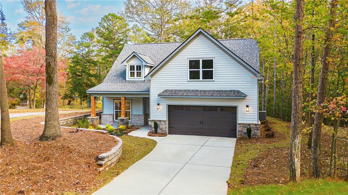 328 Point Road Westminster, SC 29693 - Photo 3 of 37 This charming home offers a perfect blend of comfort and style, nestled amidst lush trees.