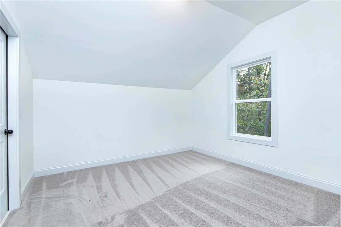 328 Point Road Westminster, SC 29693 - Photo 31 of 37 Bright, inviting room with plush carpet, perfect for a cozy retreat.