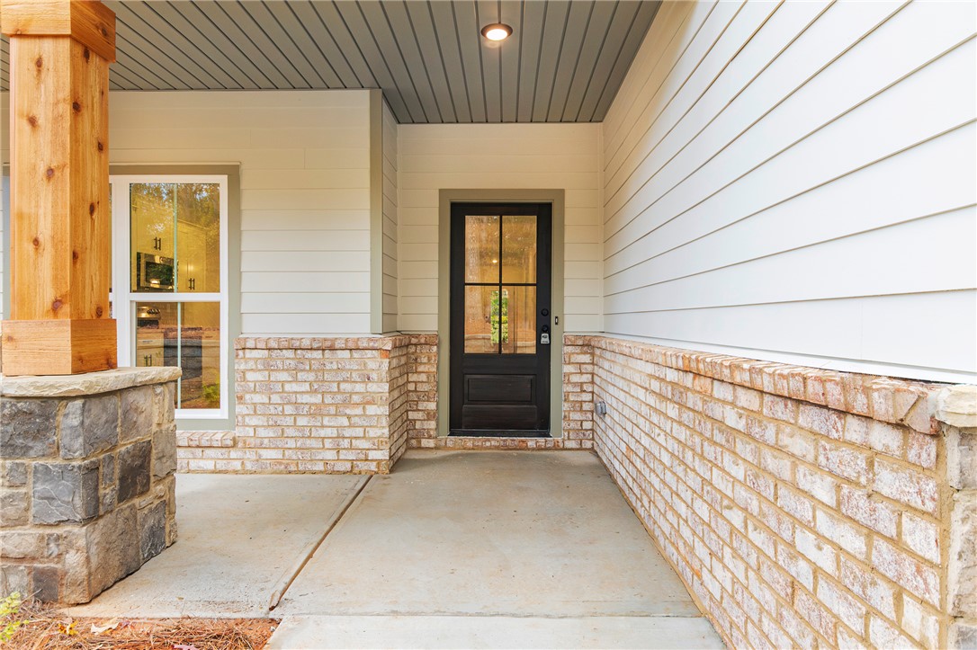 328 Point Road Westminster, SC 29693 - Photo 4 of 37 This charming front entrance features a classic black door and a welcoming concrete porch.