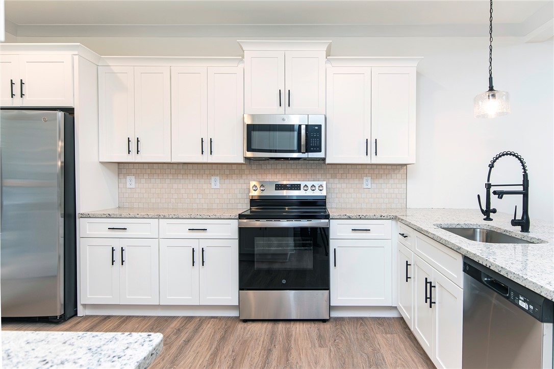 328 Point Road Westminster, SC 29693 - Photo 9 of 37 This modern kitchen features pristine countertops and integrated appliances, perfect for culinary enthusiasts.