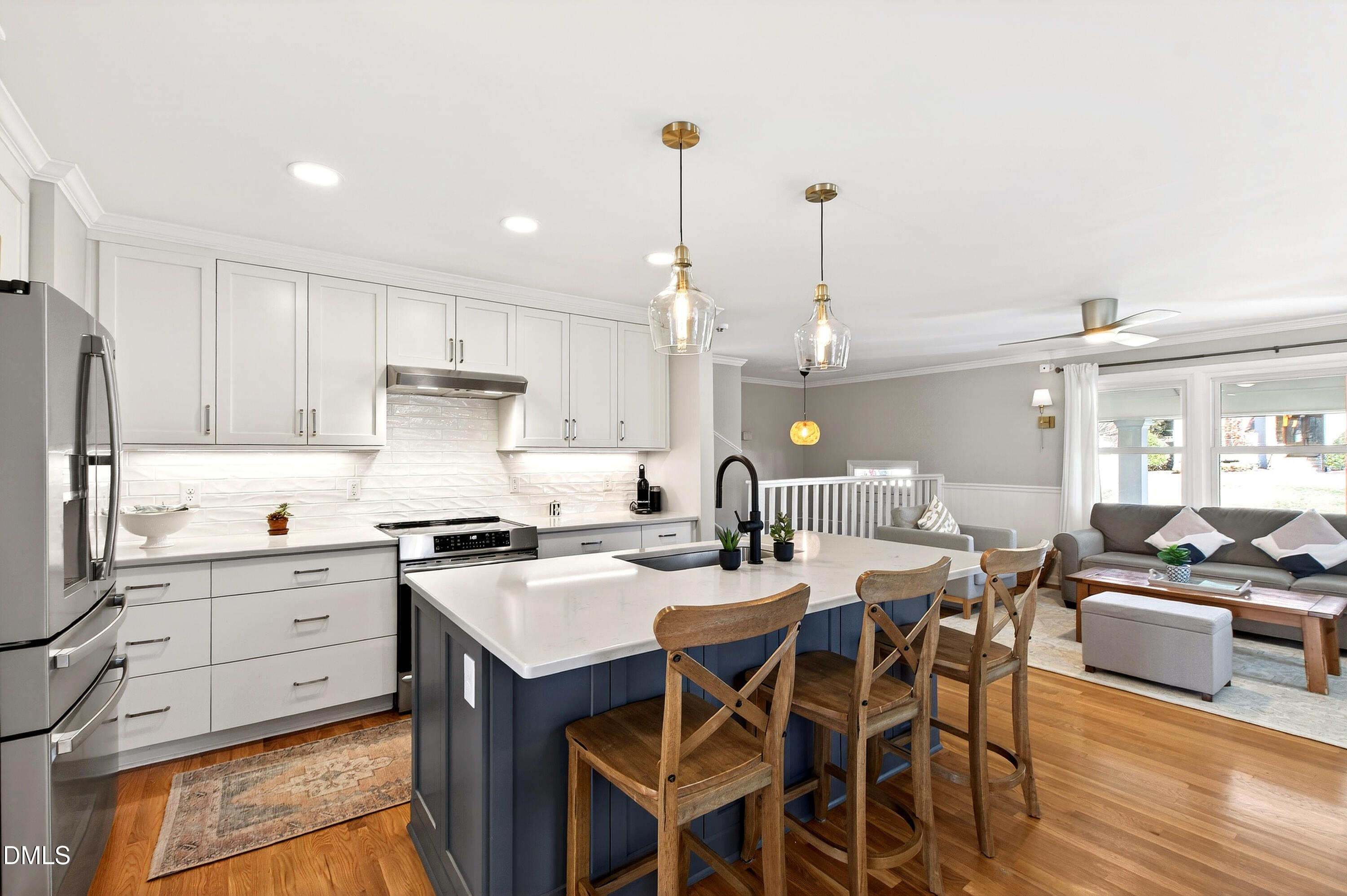 308 Latimer Road Raleigh, NC 27609 - Photo 15 of 50 a kitchen with stainless steel appliances kitchen island granite countertop a table chairs stove and white cabinets