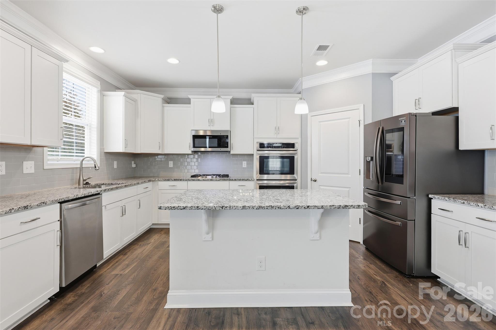 2314 Red Birch Way Concord, NC 28027 - Photo 14 of 44 a kitchen with stainless steel appliances granite countertop a refrigerator a stove a sink and white cabinets