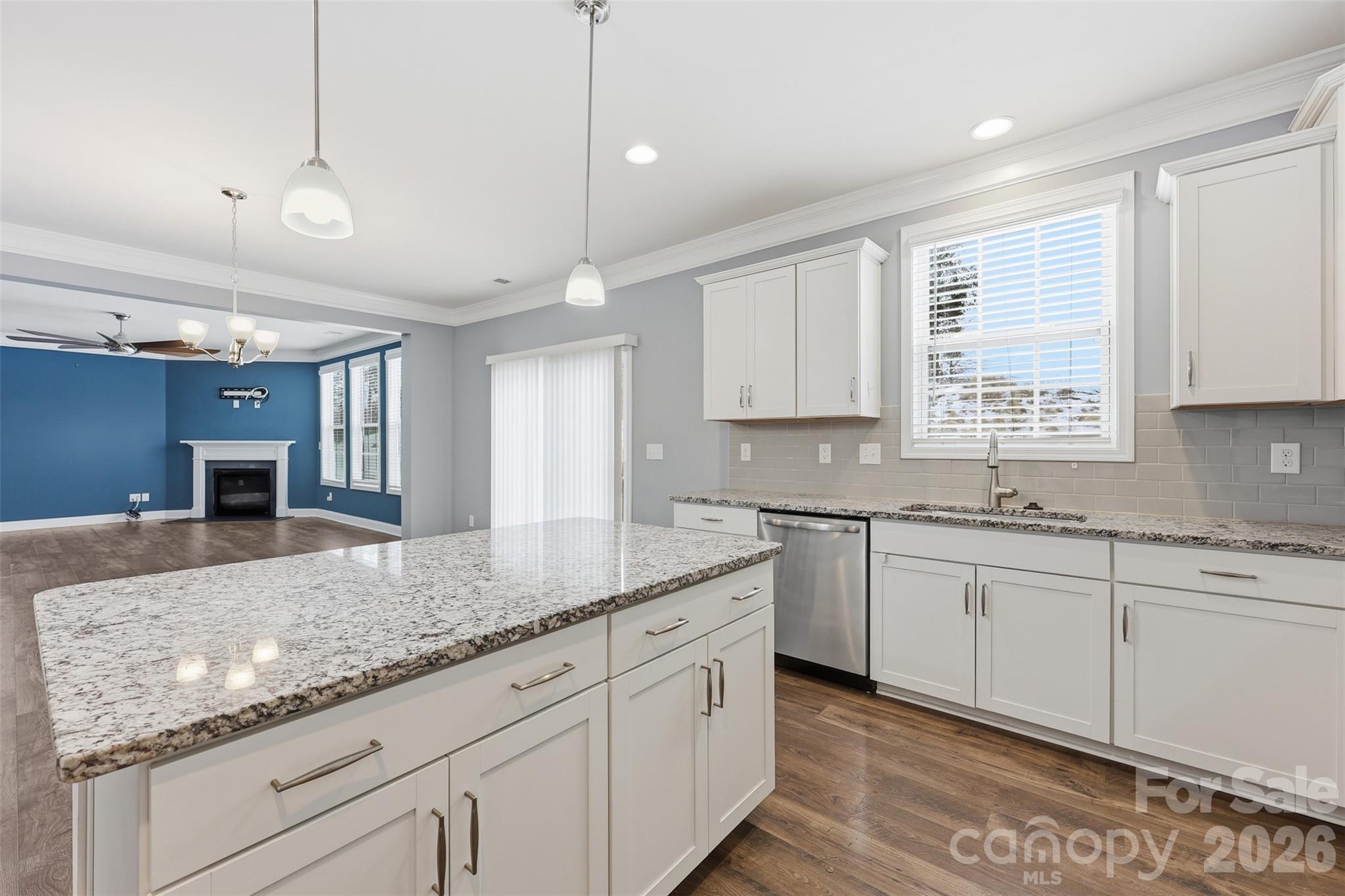 2314 Red Birch Way Concord, NC 28027 - Photo 18 of 44 a kitchen with granite countertop cabinets stainless steel appliances a sink and a window