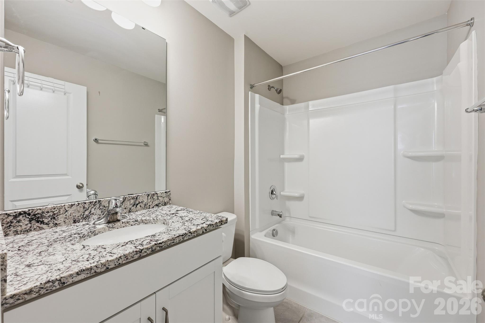 2314 Red Birch Way Concord, NC 28027 - Photo 25 of 44 a bathroom with a granite countertop sink a toilet and shower