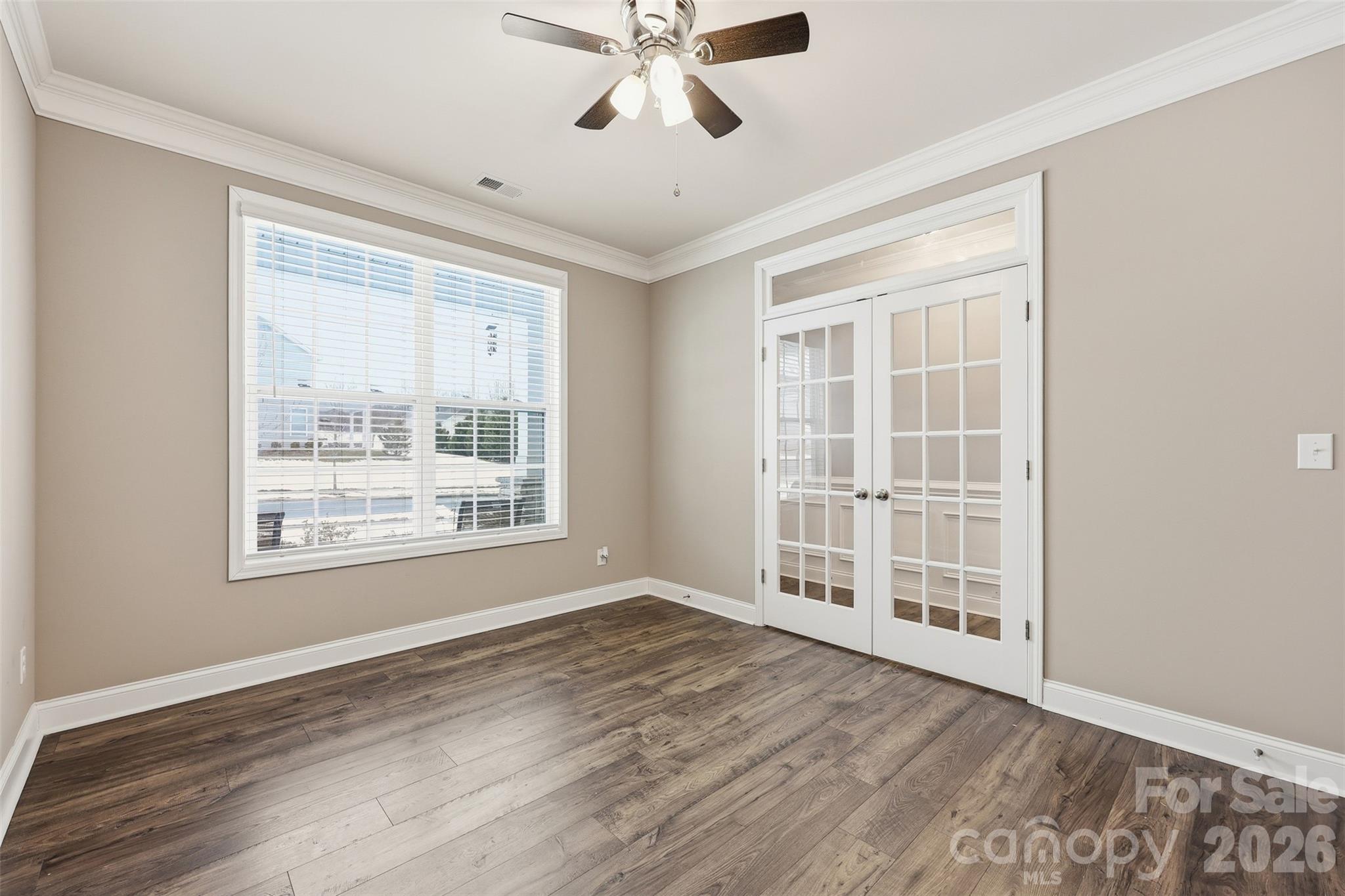 2314 Red Birch Way Concord, NC 28027 - Photo 7 of 44 a view of an empty room with a window and wooden floor