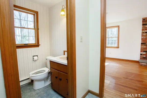 a bathroom with a toilet sink and a mirror