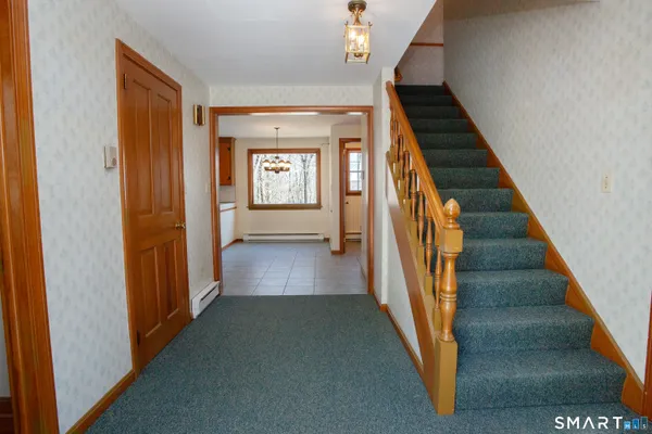 a view of a hallway with wooden floor and entryway