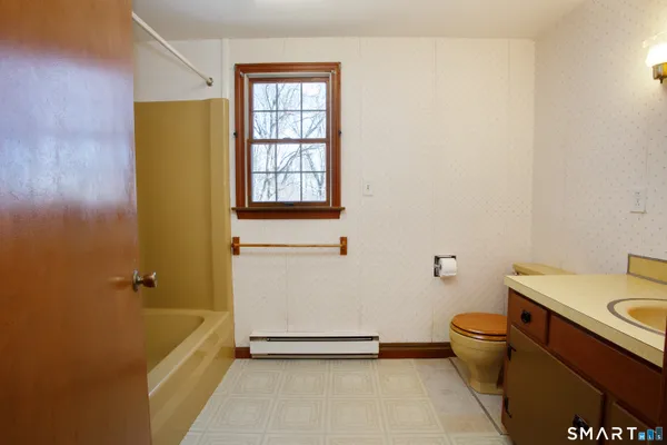 a bathroom with a sink a toilet and tub