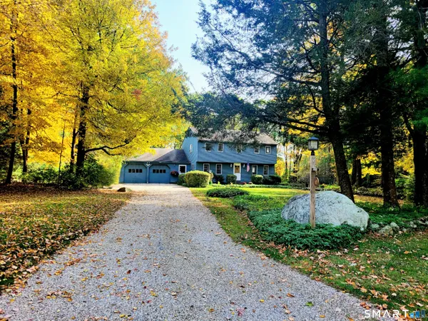 a front view of a house with a yard and shrubs