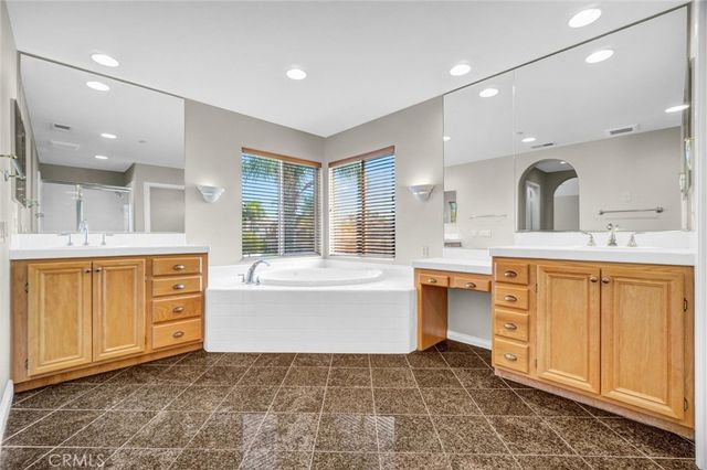 a bathroom with a glass door shower a sink and a mirror