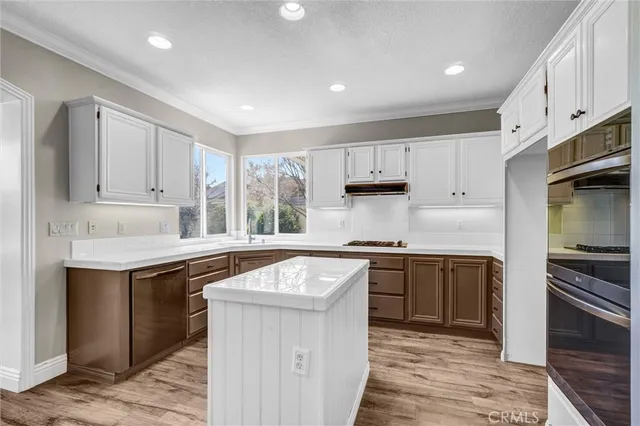 a kitchen with a sink stove and refrigerator