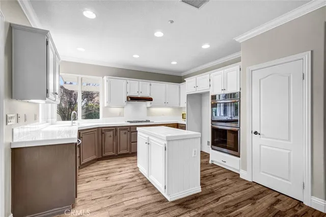 a view of a hallway with wooden floor and closet