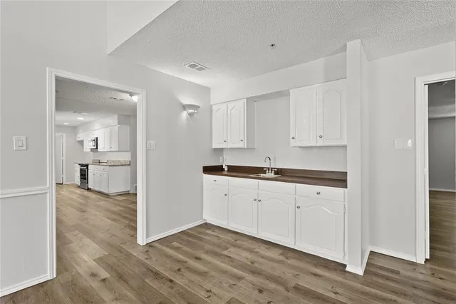 a view of a kitchen with wooden floor