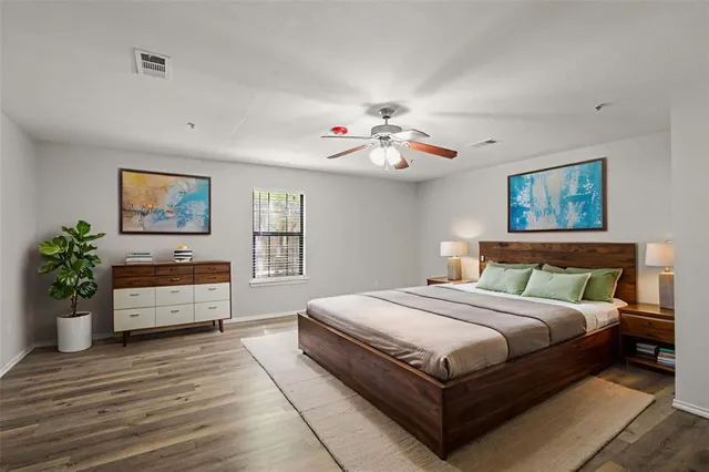 a bedroom with a large bed and a chandelier