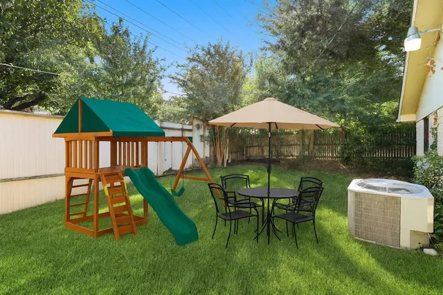 a view of a chair and table in the garden