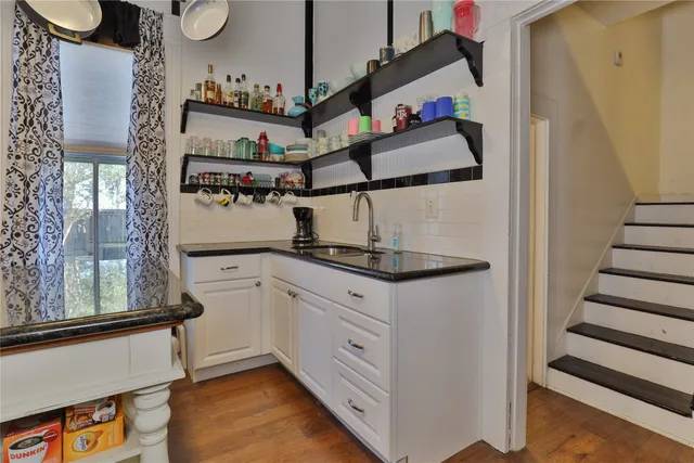 a kitchen with stainless steel appliances granite countertop a sink and a refrigerator