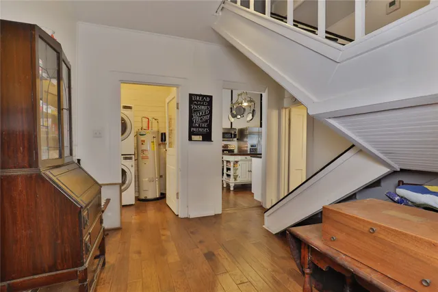 a view of a livingroom with furniture and hardwood floor